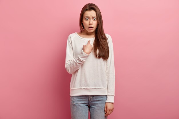 Young brunette woman in jeans and sweater