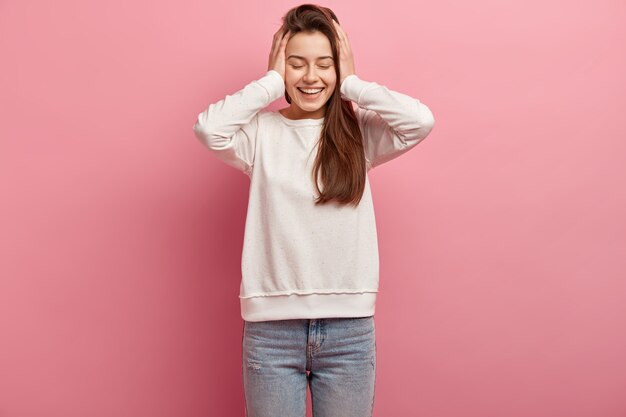 Young brunette woman in jeans and sweater