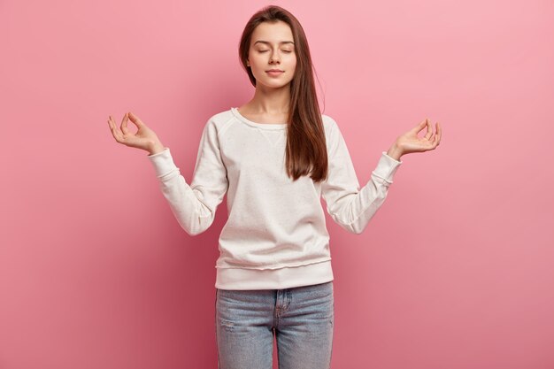 Young brunette woman in jeans and sweater