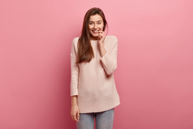 Young brunette woman in jeans and sweater