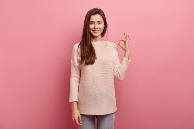 Young brunette woman in jeans and sweater