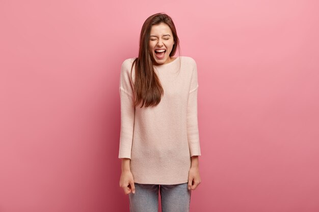 Young brunette woman in jeans and sweater