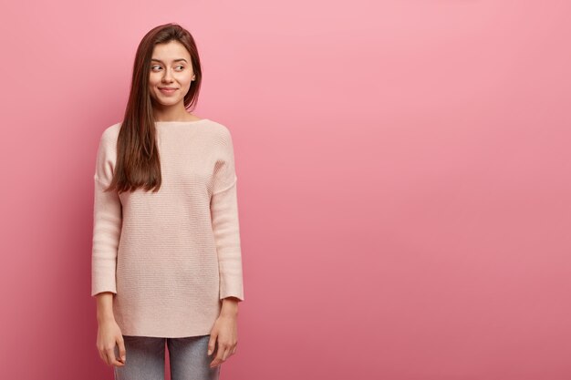 Young brunette woman in jeans and sweater