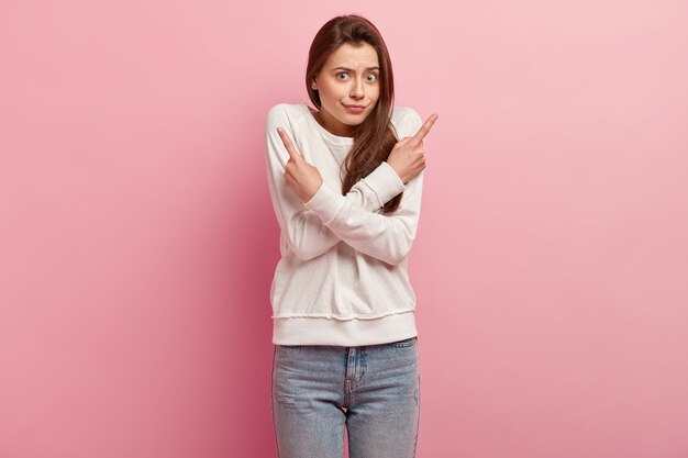 Young brunette woman in jeans and sweater