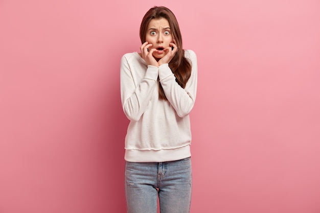 Young brunette woman in jeans and sweater