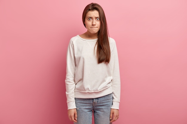 Young brunette woman in jeans and sweater