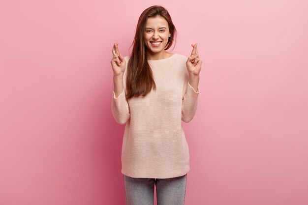 Young brunette woman in jeans and sweater