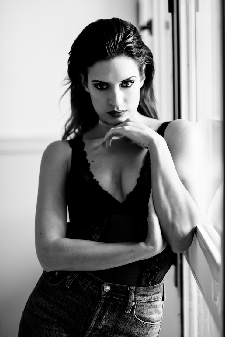 Free Photo young brunette woman looking at camera near a window. 