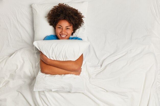 Young brunette woman lying in bed