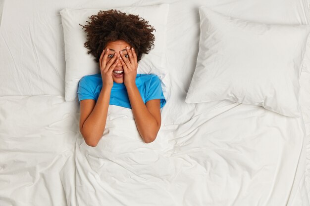 Young brunette woman lying in bed