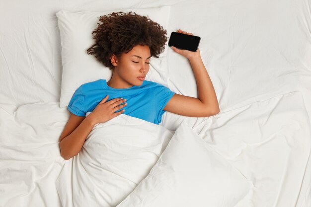 Young brunette woman lying in bed