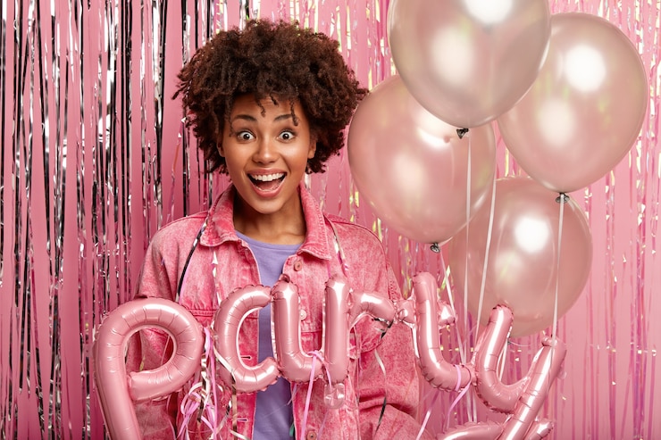 Free Photo young brunette woman at party holding balloons