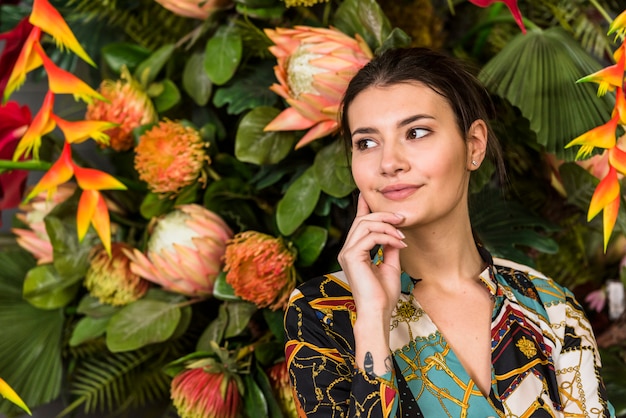 Young brunette woman posing in green house