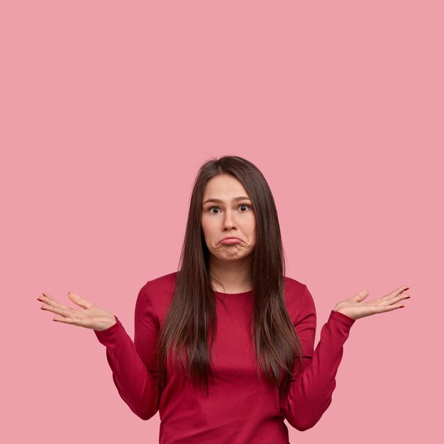 Young brunette woman in red blouse