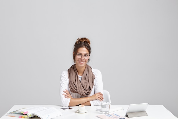 Young brunette woman sitting at desk