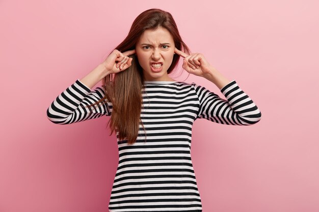 Young brunette woman in striped blouse