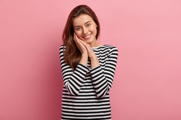 Young brunette woman in striped shirt