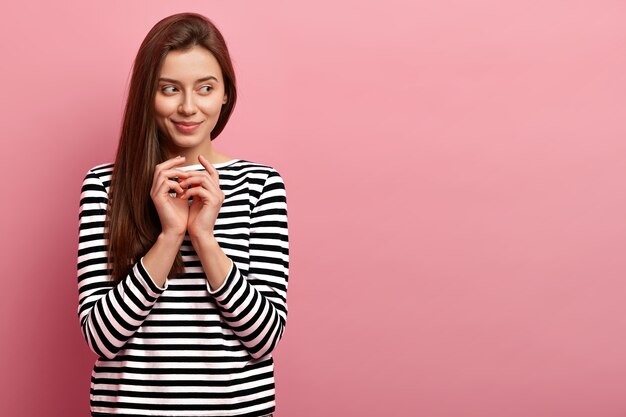 Young brunette woman in striped shirt