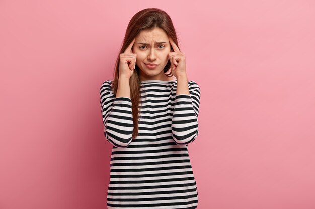 Young brunette woman in striped shirt