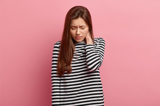 Young brunette woman in striped shirt