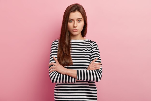 Young brunette woman in striped shirt