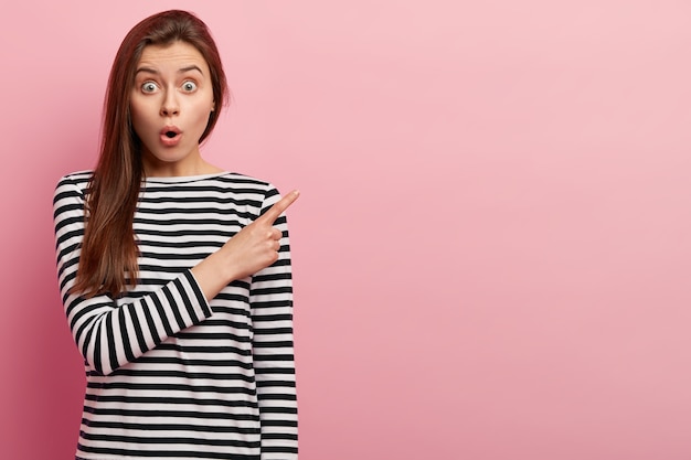 Young brunette woman in striped shirt