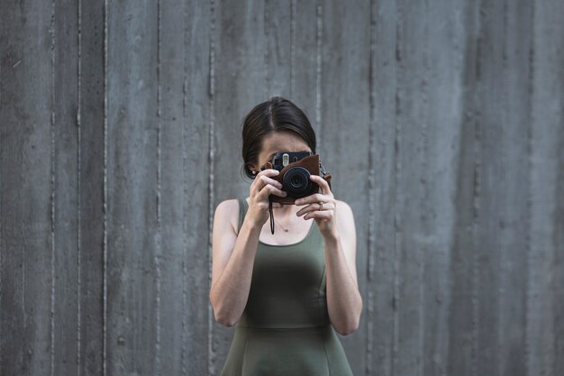 Young brunette woman taking a photo