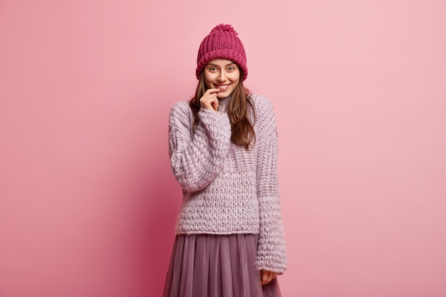 Young brunette woman wearing colorful winter clothes