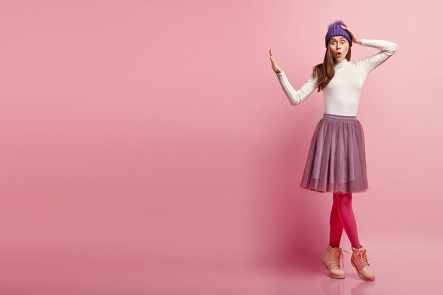 Young brunette woman wearing colorful winter clothes