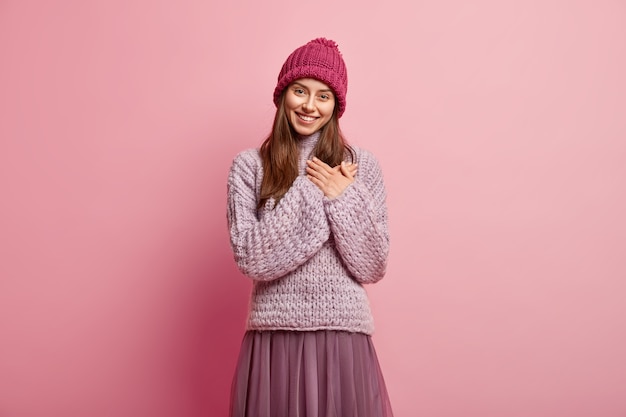Young brunette woman wearing colorful winter clothes
