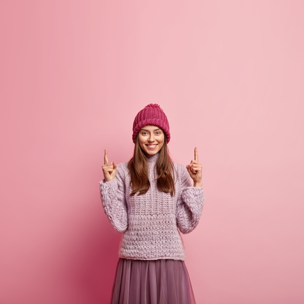 Young brunette woman wearing colorful winter clothes