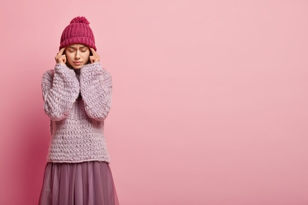 Young brunette woman wearing colorful winter clothes