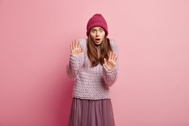 Young brunette woman wearing colorful winter clothes