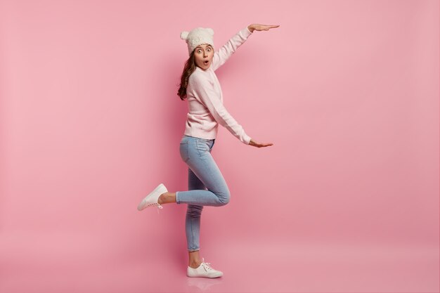 Young brunette woman wearing funny hat