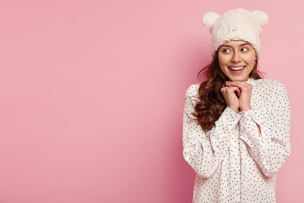 Young brunette woman wearing funny hat