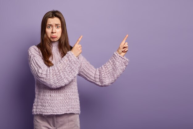 Young brunette woman wearing purple sweater