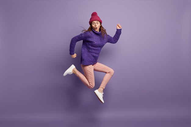 Young brunette woman wearing purple sweater