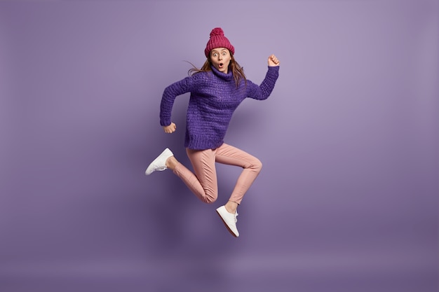 Young brunette woman wearing purple sweater