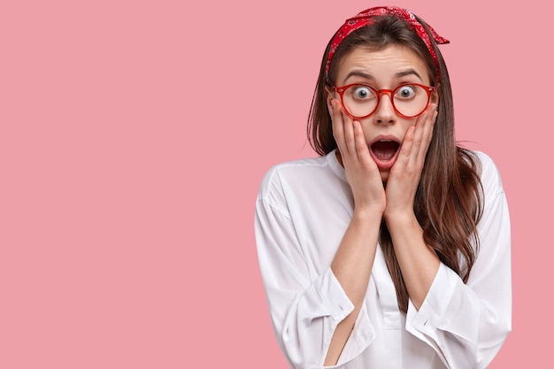 Young brunette woman wearing red bandana and eyeglasses