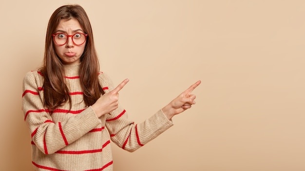 Young brunette woman wearing red glasses