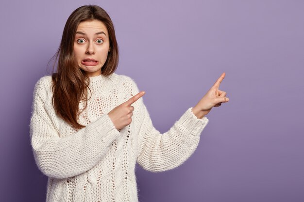 Young brunette woman wearing white sweater