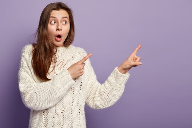 Young brunette woman wearing white sweater