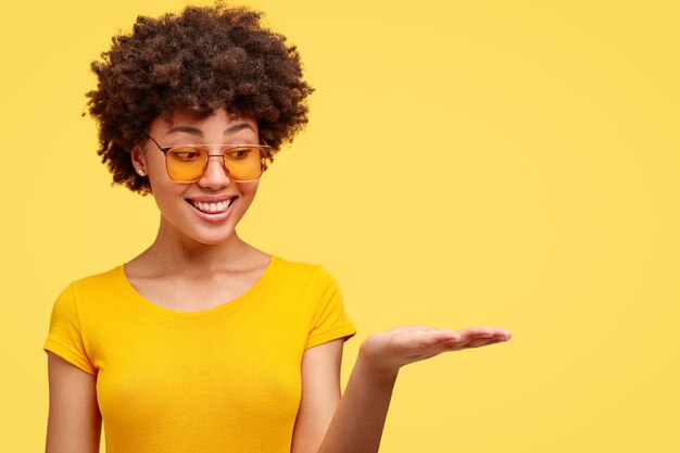 Young brunette woman with curly hair and trendy eyeglasses