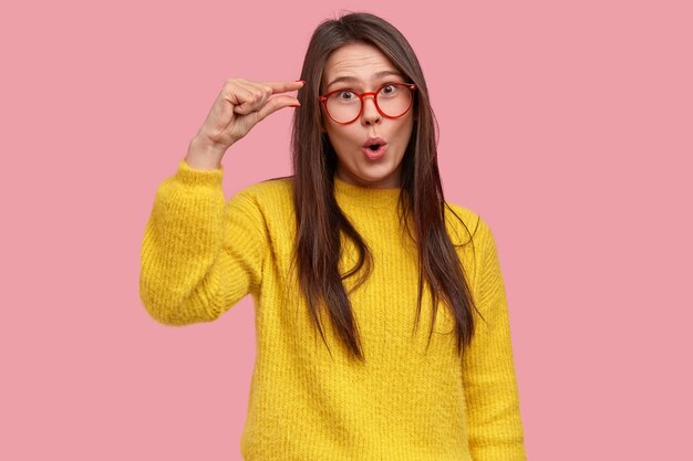 Young brunette woman in yellow sweater