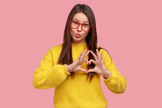 Young brunette woman in yellow sweater