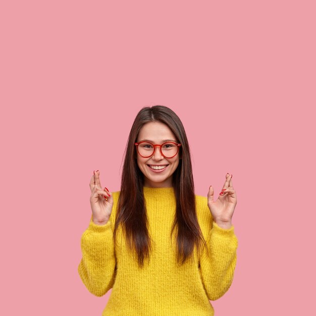 Young brunette woman in yellow sweater