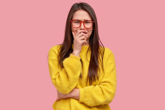 Young brunette woman in yellow sweater