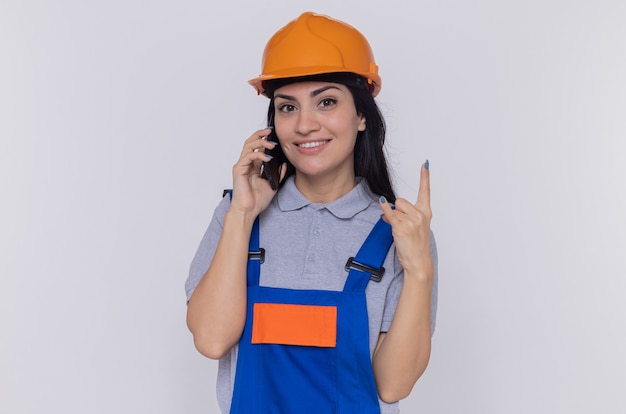 Young builder woman in construction uniform and safety helmet