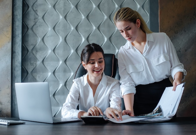 Young business lady female director sitting at office desk working process business meeting working with colleague solving business tasks office collective concept