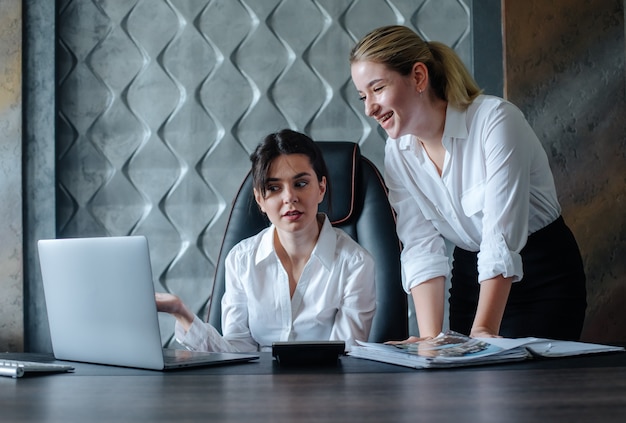 Young business lady female director sitting at office desk working process business meeting working with colleague solving business tasks office collective concept